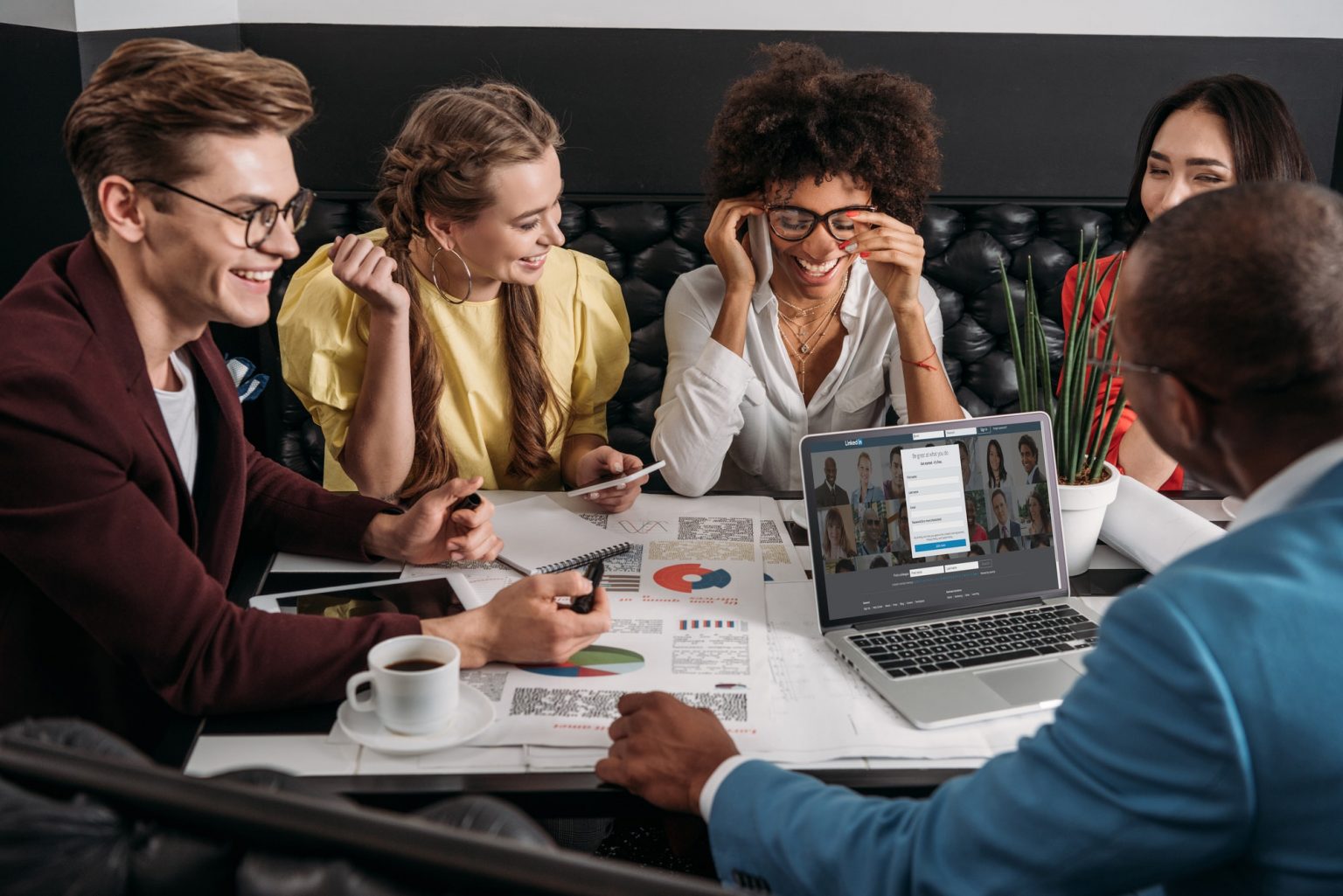 young-group-of-business-colleagues-working-together-in-cafe-1536x1025